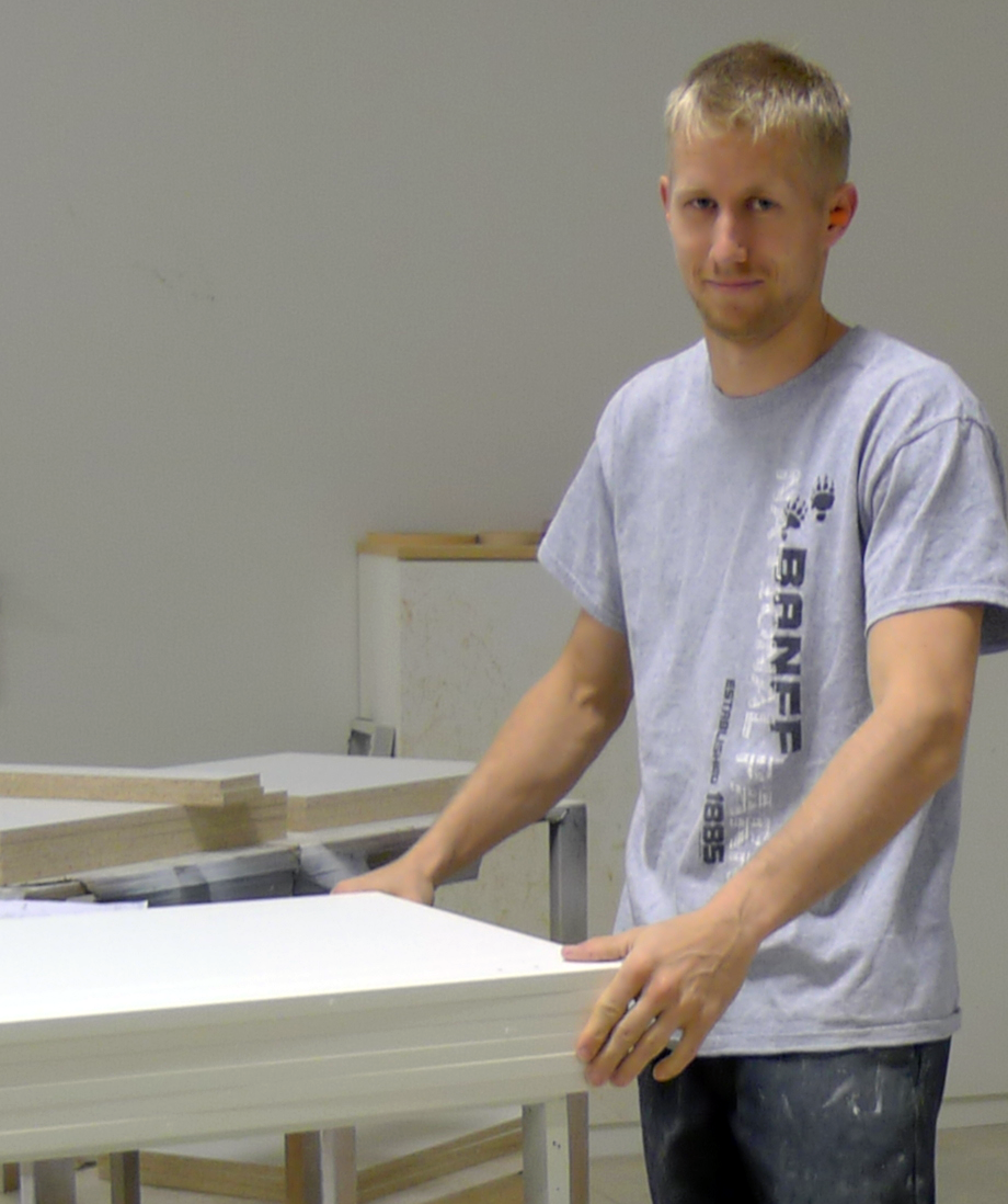 A member of the deBoer team assembling cabinetry